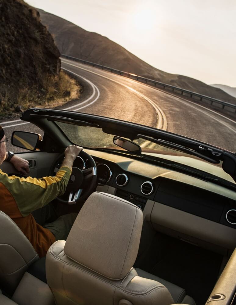 male-driver-in-a-convertible-sports-car-driving-on-2021-08-29-09-05-55-utc.jpg